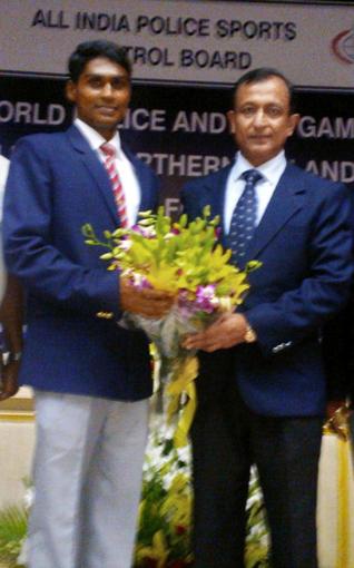 Tulasi Chaitanya, a member of the Indian team which won the relay gold in the World Police Games swimming championship in Belfast, seen with his mentor Rajiv Trivedi, Additional DGP (Sports). / The Hindu