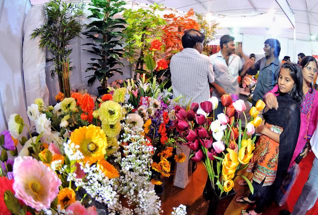 Shoppers visiting a stall selling artificial flowere at The HIndu Metro Plus Lifestyle Show 2013 organised at AU Engineering College Grounds Visakhapatnam on Wednesday./ Photo: C.V. SUBRAHMANYAM / The Hindu