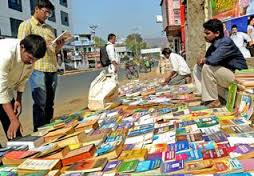 People reading books displayed by a street vendor on a footpath at Gandhi Nagar in Vijayawada.- Photo: Ch. Vijaya Bhaskar / The Hindu