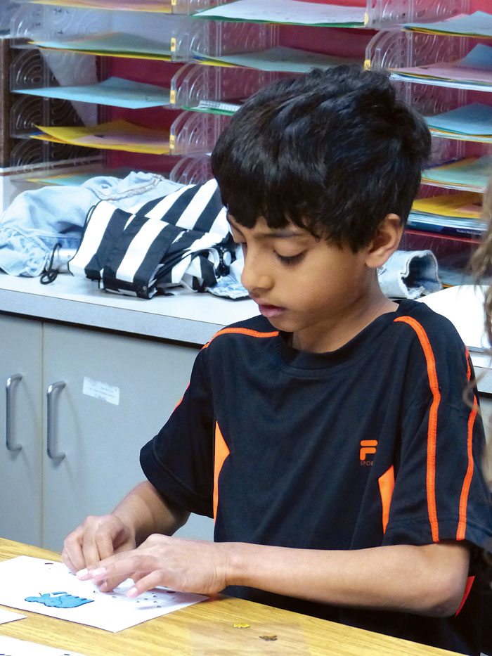 Fifth-grader Aakash Narayan creates a braille book for the Devnar Foundation in Hyderabad, India, near where he’s from in India. (Sun Current staff photos by Lisa Kaczke)