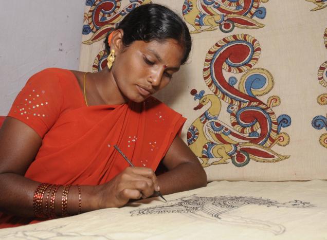 A Kalamkari artist immersed in designing a piece of cloth. / File Photo / The Hindu