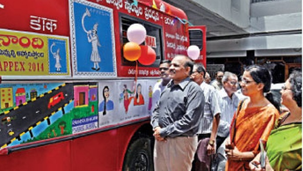 Chief postmaster general BV Sudakar (left) takes a look at the Naandi Ratham, the publicity vehicle of the postal department in Vijayawada on Tuesday | Express Photo
