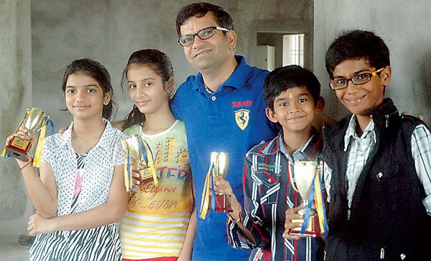 The Bright Bunch: Rajendra S. Jain’s students, from left, Chavi, Kusum, Jay and Moksh strike a pose with the trophies they won at National Memory Championship. (Photo: DC)