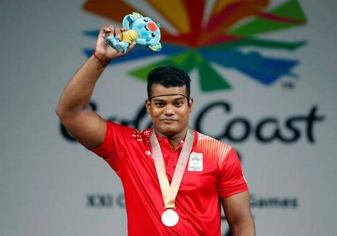 Gold medalist Venkat Rahul Ragala of India celebrates on the podium. | Photo Credit: Reuters